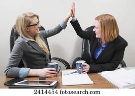 Co-workers celebrate teamwork and accomplishments; Edmonton, Alberta, Canada