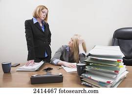 Supervisor scowling at employee over lack of work accomplishment; Edmonton, Alberta, Canada