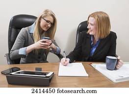 Supervisor teaching intern about accounting practises; Edmonton, Alberta, Canada