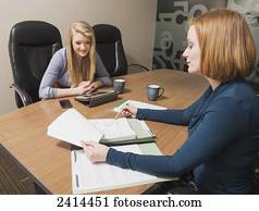 Supervisor teaching intern about accounting practises; Edmonton, Alberta, Canada