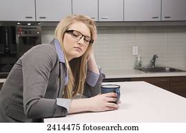 Young office worker asleep in the coffee room; Edmonton, Alberta, Canada