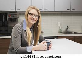 Young office worker at coffee break; Edmonton, Alberta, Canada