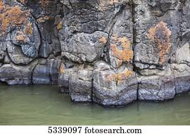 Lichen coloured basalt columns of Miles Canyon; Whitehorse, Yukon, Canada