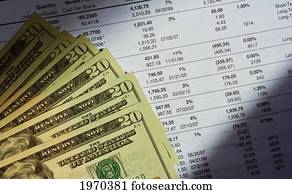 A Stack Of Money Lying On A Stock Investment Portfolio