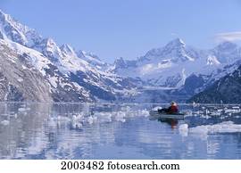 Alaska, Glacier Bay, View Of Snow Covered Mountains Boat And Ice Chunks Floating In Lake