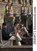 Book Reading Couple Relax At Tiled Plaza Espana
