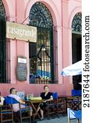 Couple Having A Drink In A Colonial Style Restaurant In The Old Town Of Colonia De Sacramento, Uruguay, South America Couple Having A Drink In A Colonial Style Restaurant In The Old Town Of Colonia De Sacramento, Uruguay, South America