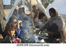 Family Having Breakfast In A Relief Camp Tent After The 8 October 2005 Earthquake, Bagh, Azad Kashmir, Pakistan
