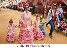 Family In Traditional Dresses During April Feria Festival; Seville, Andalucia, Spain