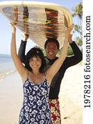 Hawaii, Local Couple Walking Along Beach With Surfboards. Hawaii, Local Couple Walking Along Beach With Surfboards.