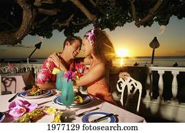 Hawaii, Oahu, Couple At A Restaurant At Sunset. Hawaii, Oahu, Couple At A Restaurant At Sunset.