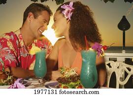 Hawaii, Oahu, Couple At A Restaurant At Sunset. Hawaii, Oahu, Couple At A Restaurant At Sunset.