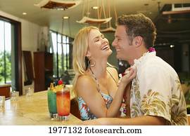 Hawaii, Oahu, Couple Having Drinks At A Bar. Hawaii, Oahu, Couple Having Drinks At A Bar.