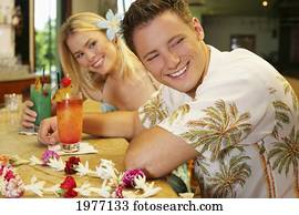 Hawaii, Oahu, Couple Having Drinks At A Bar. Hawaii, Oahu, Couple Having Drinks At A Bar.