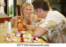 Hawaii, Oahu, Couple Having Drinks At A Bar. Hawaii, Oahu, Couple Having Drinks At A Bar.