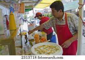 Mexico, Aguascalientes state, Aguascalientes, Street side vendor preparing fruit cup