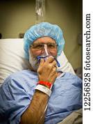 Senior male in hospital bed prepped for surgery; Delta, British Columbia, Canada