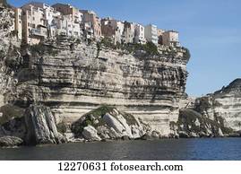 Dramatic view of houses on cliff from sea; Bonifacio, Corse-du-Sud, Corsica, France