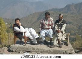 Men Sitting On A Bench Placed On The Rubble After The 8 October 2005 Earthquake, Chikar, Azad Kashmir, Pakistan