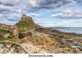 Rocky outcrop leading to Holy Island Castle on a beautiful spring day