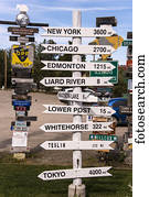 Signpost forest displaying numerous destination and distance signs; Watson Lake, Yukon, Canada