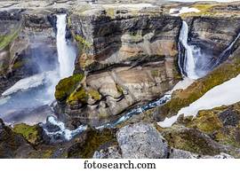 The stunning earthy colors and rock formations along with unmelted snow resting in the bottom of the Haifoss valley among two waterfalls.  Natural beauty in one of Iceland's great hiking viewpoints; Iceland