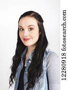 Portrait of a young woman with long dark hair on a white background; Alberta, Canada