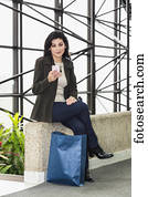 Business woman taking a shopping break during her work day; Edmonton, Alberta, Canada Business woman taking a shopping break during her work day; Edmonton, Alberta, Canada