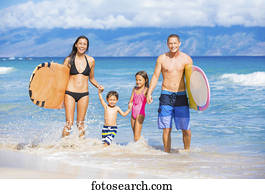 Happy Family with Surfboards on the Beach in Hawaii