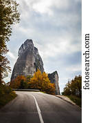 Rugged cliffs, road and autumn foliage; Meteora, Greece