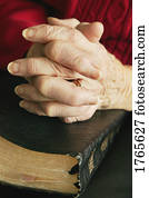 Senior praying with Bible