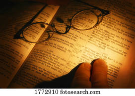 Open bible with glasses resting on it