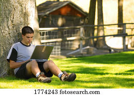Teen boy working on lap top