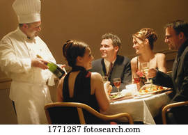 Couples having dinner in a restaurant