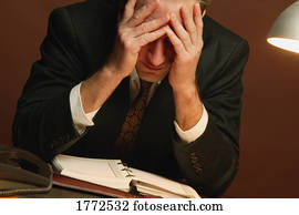 Businessman with head in hands