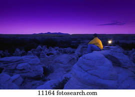 Hiker watching the sky in twilight
