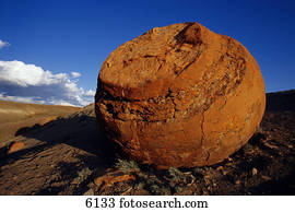 Large red boulder in desert valley Red Rock Coulee Alberta