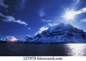 Snow-covered mountains across lake