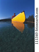 Man in yellow canoe on lake