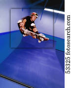 Skateboarder at top of jump