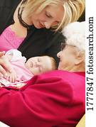 A lady, a senior woman, and a baby A lady, a senior woman, and a baby