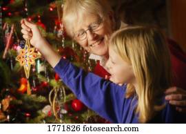 Family members dressing the Christmas tree