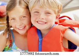 Two children hugging outdoors (outside)