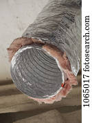 An open air duct pipe with insulation around it