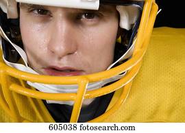 American football player wearing red football strip and black face