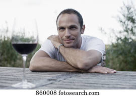 A man sitting at an outdoor table, non-urban scene