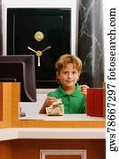 Boy imitating a cashier in a bank and counting currency notes