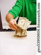 Close-up of a boy holding currency notes