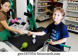 Portrait of a boy giving paper currency to a sales clerk