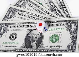 Close-up of a dice on US paper currency